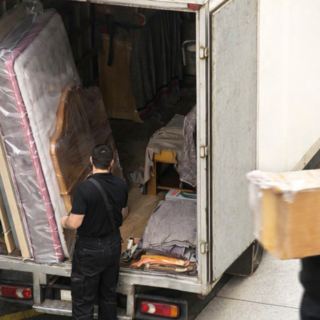 Professional movers loading wrapped furniture securely into moving truck – Easy Best Moves